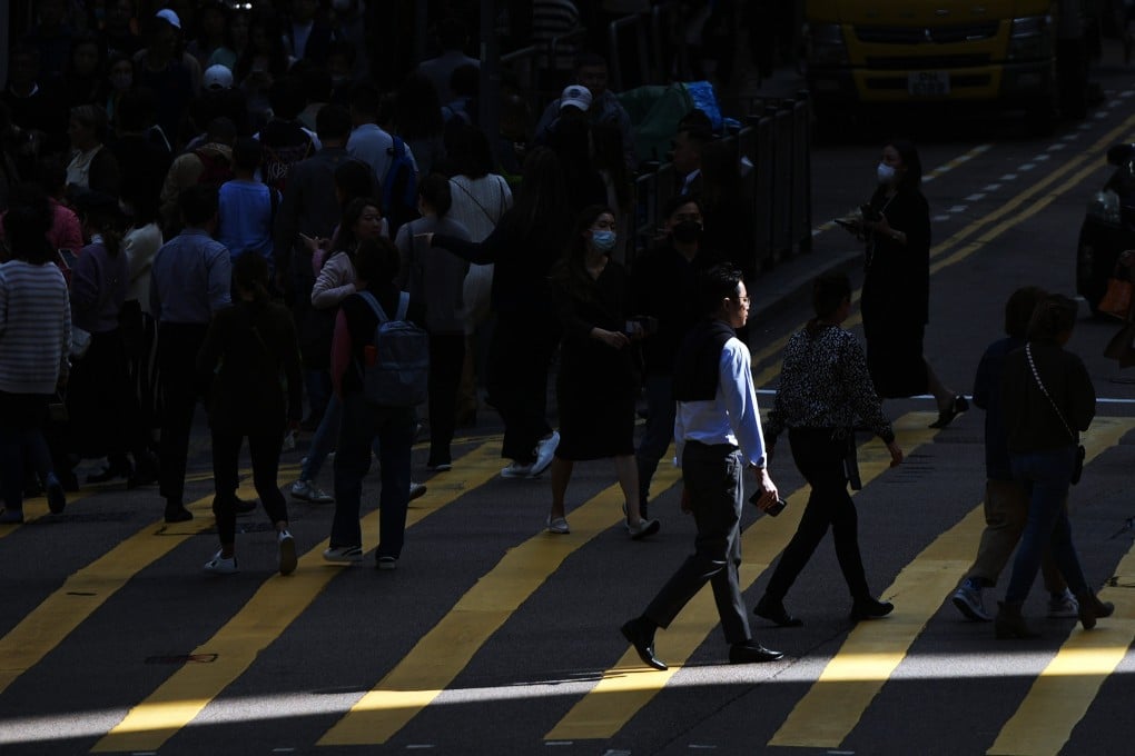 Pedestrians cross a street in Hong Kong’s Central district on January 18, 2024. Photo: Eugene Lee