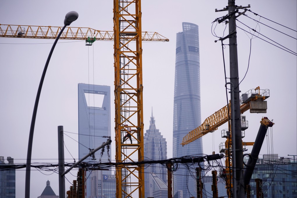 A worker climbs a crane at a construction site in front of the Lujiazui financial district in Shanghai in July 2020. Commericial real estate transaction volumes in China were the highest in Asia last year. Photo: Reuters