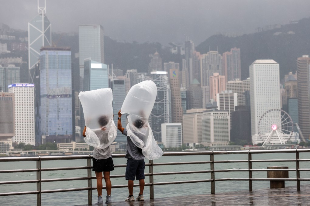 People at the Tsim Sha Tsui promenade feel the effects of Typhoon Saola on September 1, 2023. As extreme weather becomes more frequent around the world, pressure on businesses to reduce carbon emissions has grown. Photo: Yik Yeung-man