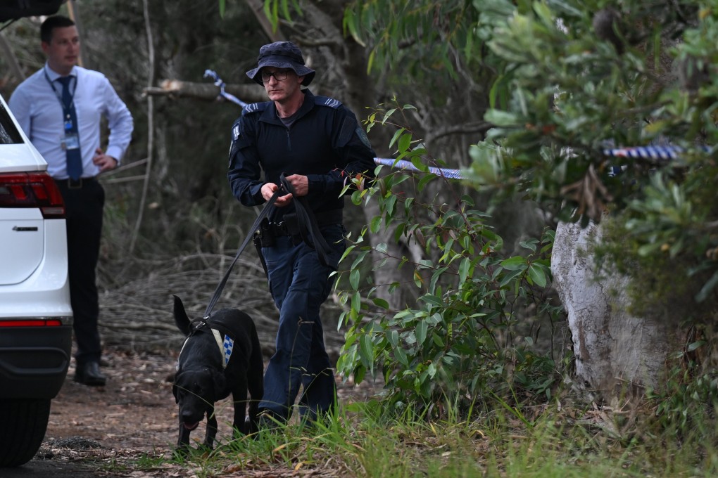 Police search bushland with a police sniffer dog in the Royal National Park south of Sydney, New South Wales Australia, on Tuesday. Photo: EPA-EFE