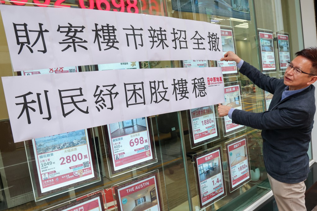 An estate agent in Jordan puts up a sign to highlight the removal of curbs on the property market after the budget statement. Photo: Jelly Tse