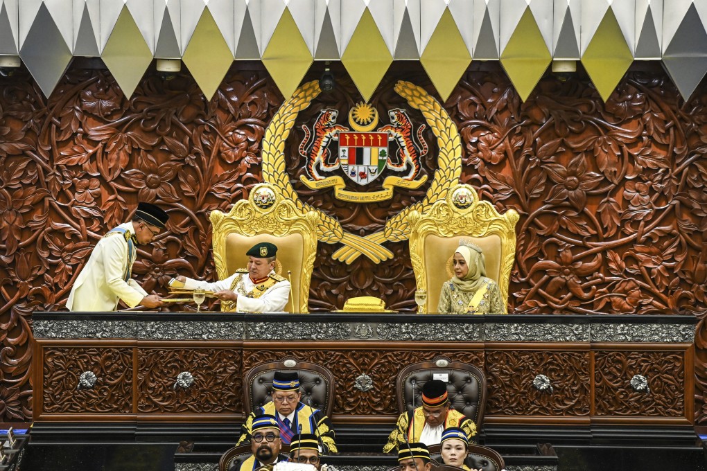 Malaysia’s king Sultan Ibrahim Iskandar receives documents from Prime Minister Anwar Ibrahim as queen Raja Zarith Sofiah looks on during the opening ceremony of the parliamentary session at parliament house in Kuala Lumpur. photo: AP