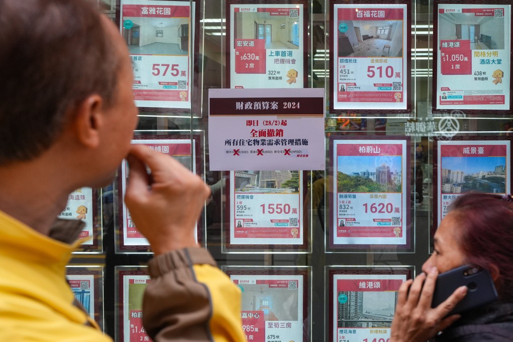 The end of restrictions designed to cool the property market are highlighted in the window of a property agency Photo: Eugene Lee