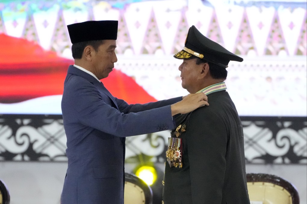 Indonesian Defence Minister Prabowo Subianto, right, receives four-star general epaulettes from President Joko Widodo on Wednesday. Photo: AP