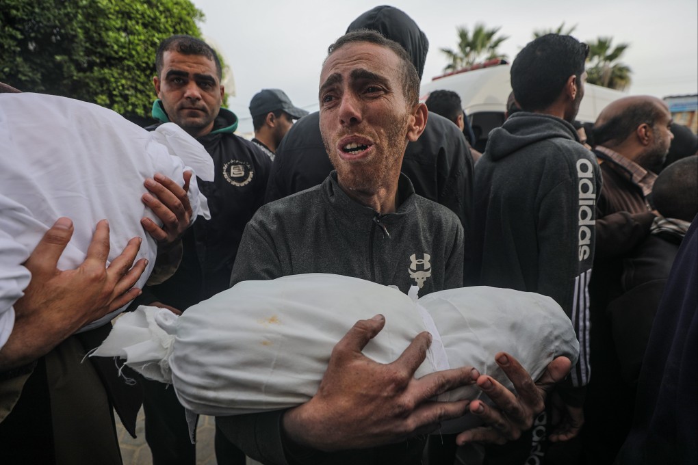 A father carries the body of his son following an Israeli air strike on Deir Al Balah, southern Gaza Strip. Photo: EPA-EFE