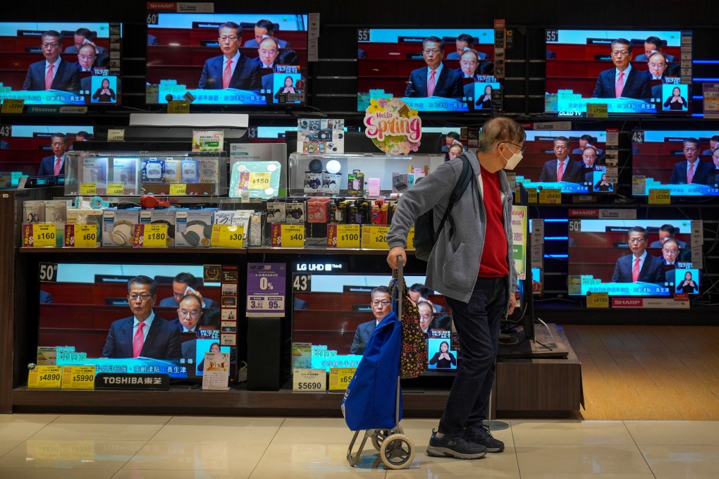 TV sets in a Tai Koo electronics store display the live broadcast of Financial Secretary Paul Chan’s budget speech. Photo: Eugene Lee