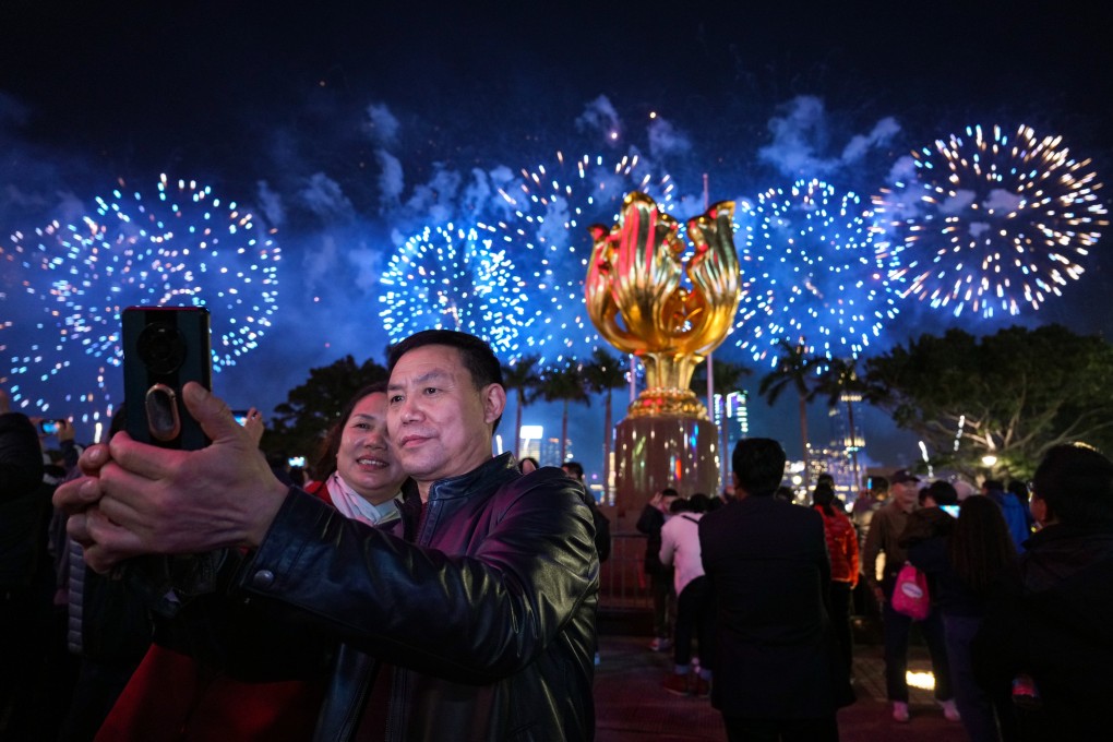 Visitors gather for a fireworks display at Golden Bauhinia Square during the Lunar New Year. Photo: Eugene Lee