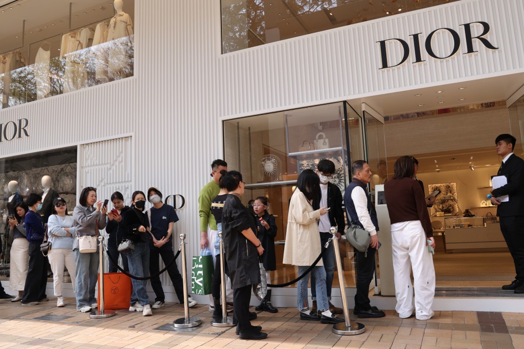 Shoppers outside a luxury retail store. The city recorded 34 million visitors last year, just over half the record 65 million who came in 2018. Photo: Jelly Tse