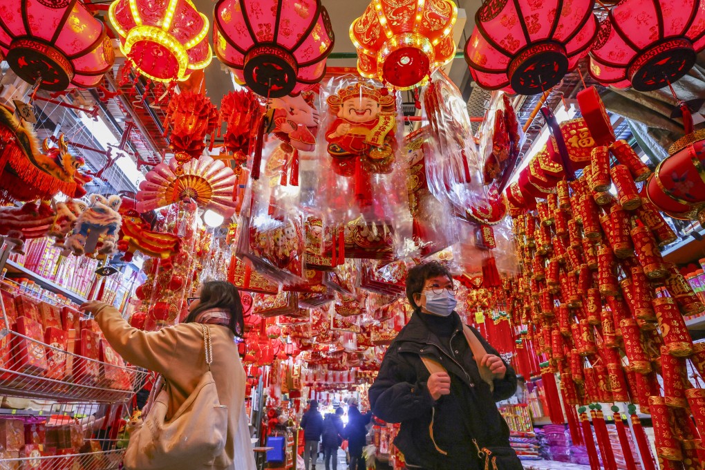 Shoppers select Lunar New Year decorations and red packets amid a sea of festive ornaments at Tai Kiu market in Yuen Long on January 28. Photo: Dickson Lee