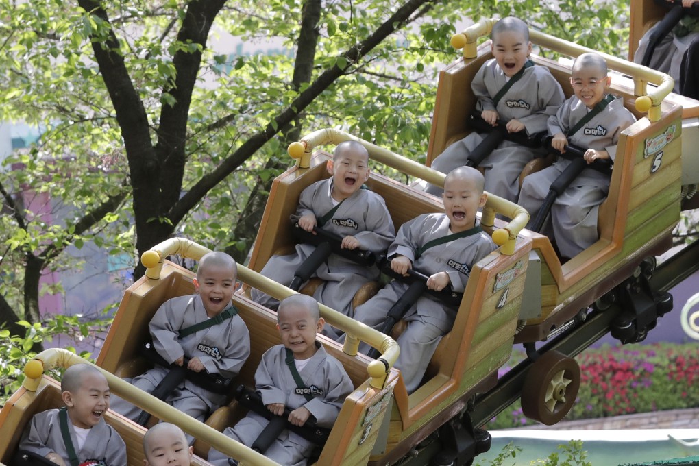 Children ride a roller coaster at an amusement park in Yongin, South Korea. Since 2018, the country has been the only OECD member to have a birth rate below 1. Photo: AP