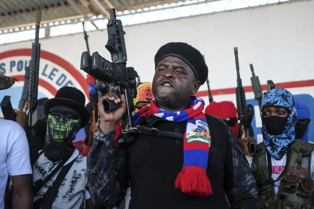 Gang leader Jimmy Cherizier, better known as Barbecue, shouts slogans with his gang members after giving a speech in Port-au-Prince, Haiti, in October 2021. File photo: AP