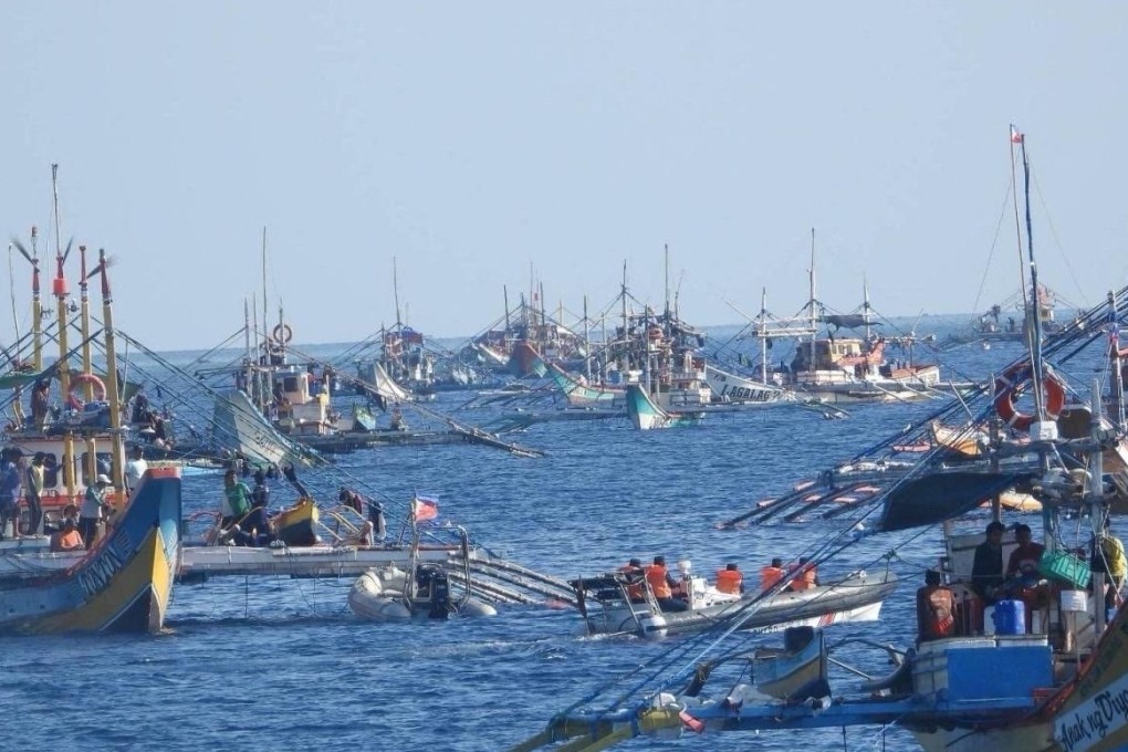 China coastguard personnel in a rigid-hulled inflatable boat shadow a Philippine Bureau of Fisheries and Aquatic Resources boat delivering supplies to fishermen near the Scarborough Shoal in the disputed South China Sea last month. Photo: Philippine Coast Guard/ Handout via AFP