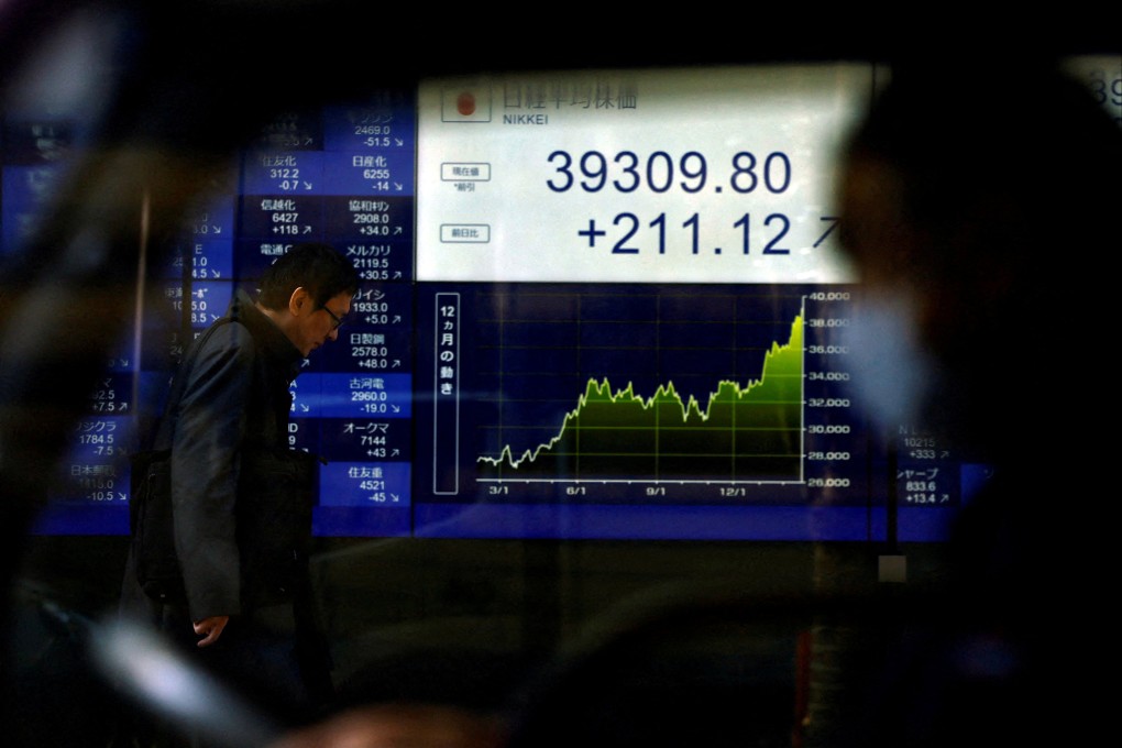 An electronic screen displays Japan’s Nikkei index as the share average hits a record high in Tokyo on February 26. We should be re-examining the role of private and public sectors in allocating financial resources to the global economy. Photo: Reuters