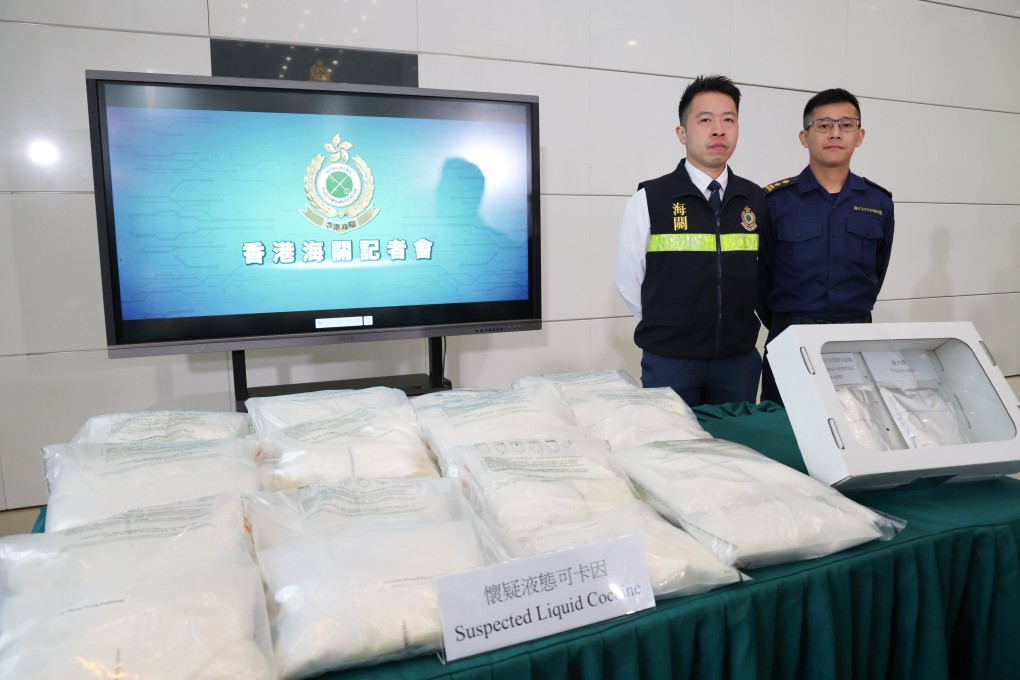 Lee Chi-ho, senior investigator, (left) and Chan Kit-lun, acting senior inspector, hold a press briefing on the seizure of liquid cocaine found in a shipment from Brazil. Photo: Handout
