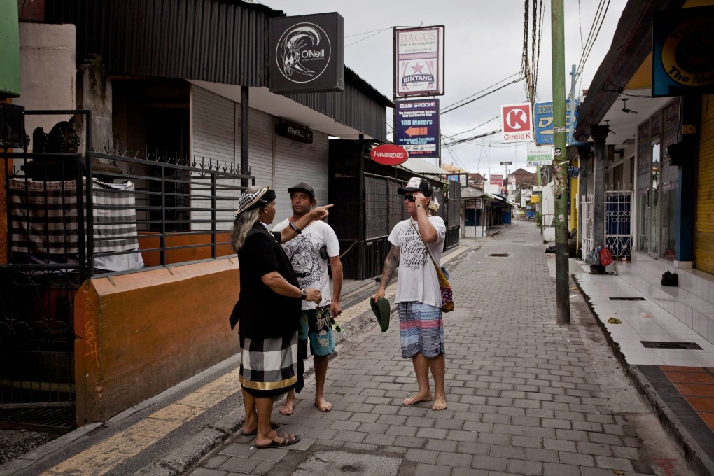 Nyepi Day, the Balinese New Year, is celebrated with a day of silence and inactivity. Above: a pecalang (community guard) warns tourists to return to their hotel during Nyepi Day in 2013. Photo: Getty Images