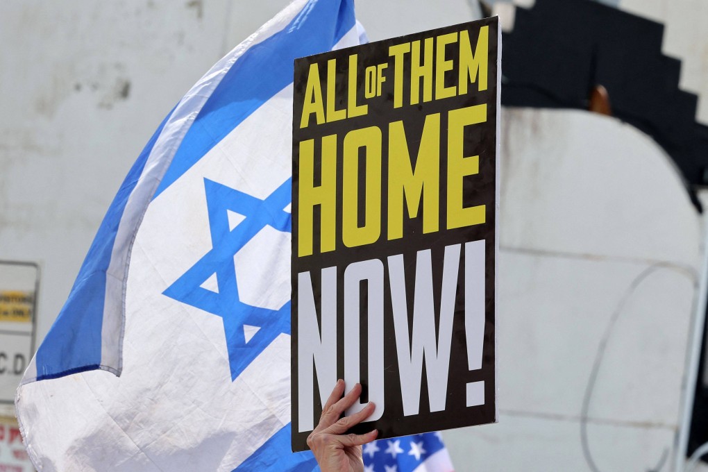 A protester holds a placard calling for the release of Israeli hostages in Gaza outside the Branch Office of the US embassy in Tel Aviv on Friday. Photo: AFP