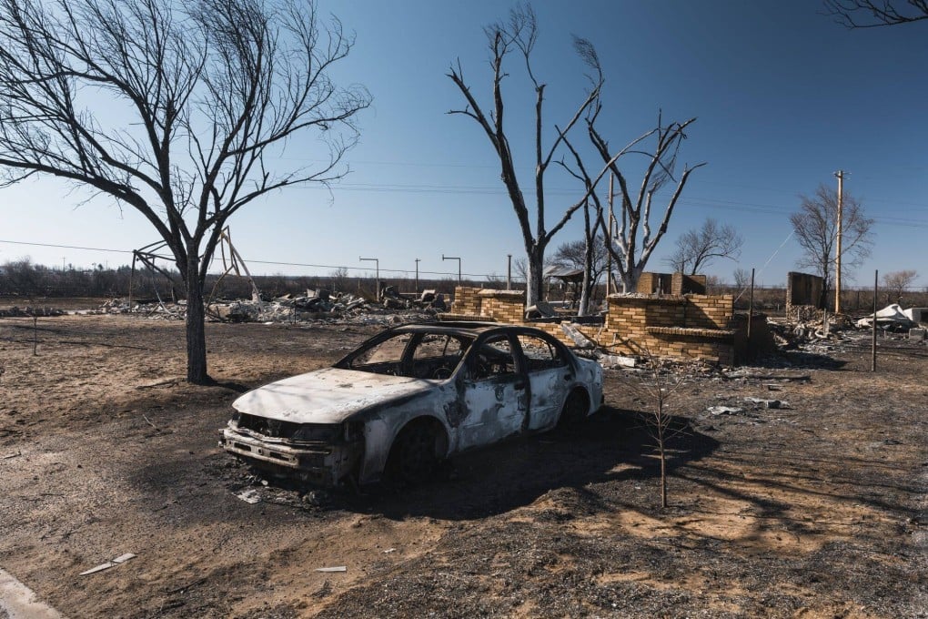 A burned car and home following a wildfire in Fritch, Texas, on Friday. Photo: Bloomberg