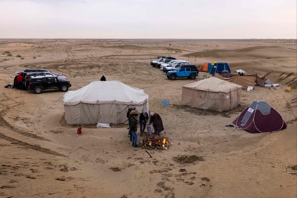 Campers gather around a fire in Iraq’s Samawah desert. Desert camping is becoming increasingly popular in the country as war becomes a distant memory and young men look for “safe” adventures among the sand dunes. Photo: AFP