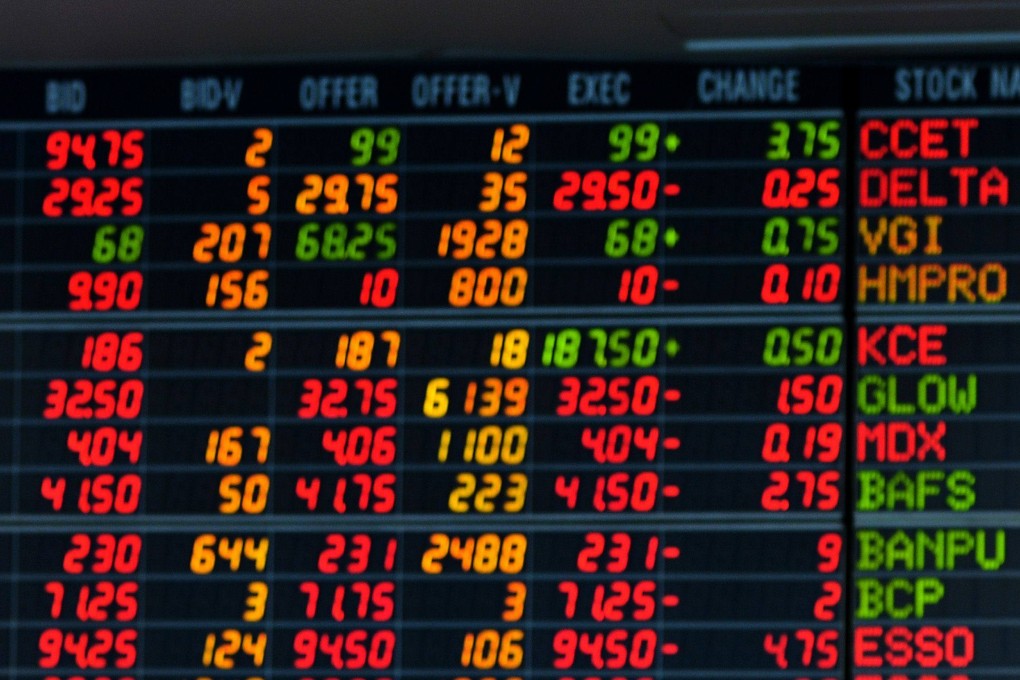 A Thai investor looks at an electronic display of share prices at a private trading company in Bangkok. Photo: AFP