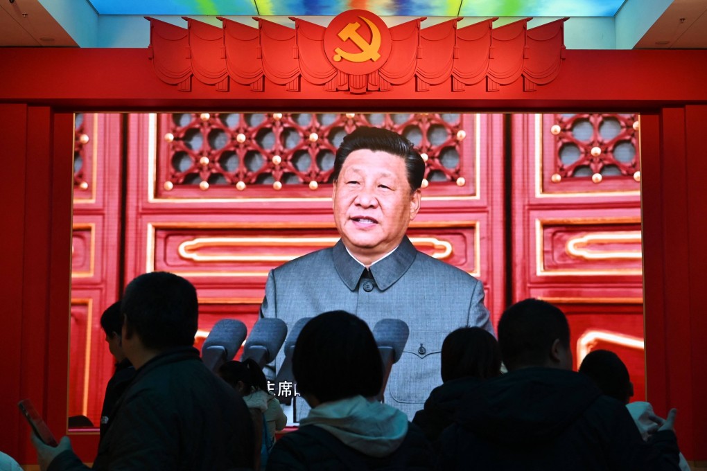 People watch a video featuring President Xi Jinping at the Military Museum in Beijing. Photo: AFP