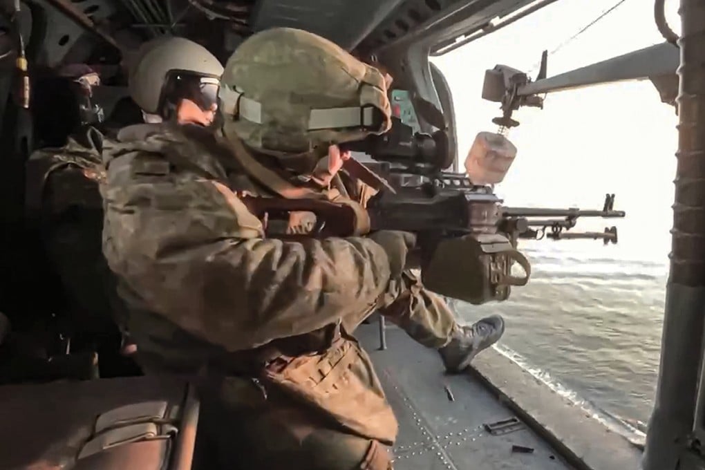 Russian soldiers fire from a helicopter during a patrol of the Black Sea in this still taken from a video released by the Russian Defence Ministry earlier this year. Photo: Russian Defence Ministry Press Service via AP