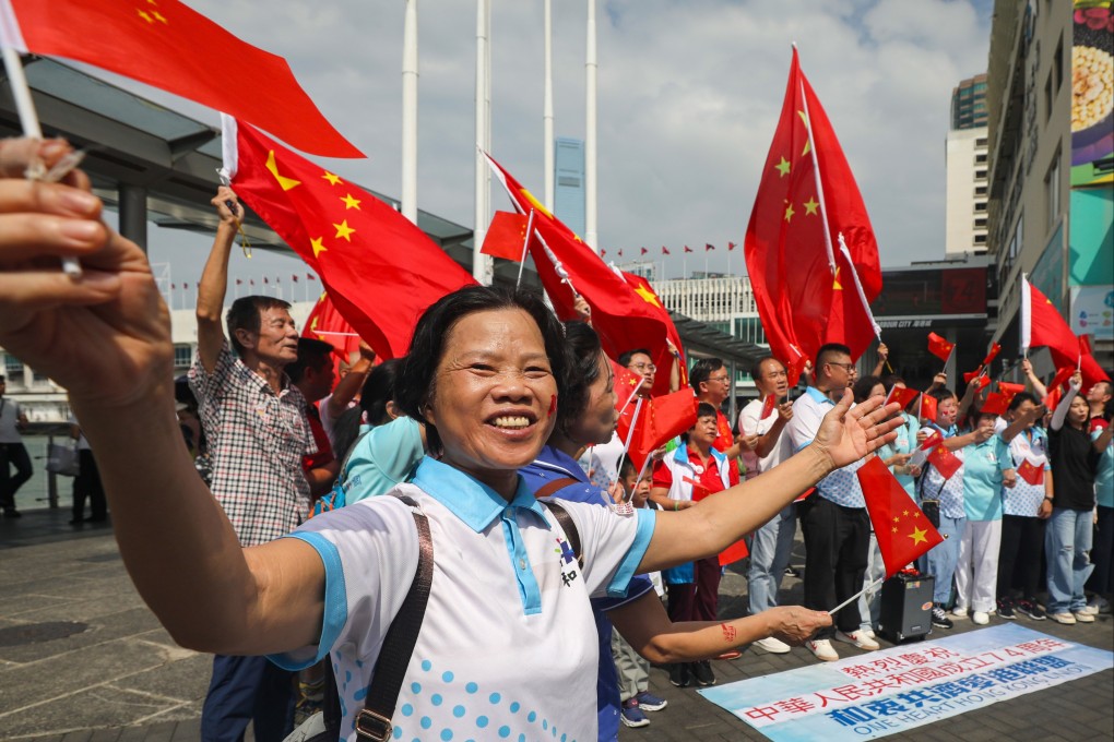 People wave Chinese flags in Tsim Sha Tsui on National Day last year. The Social Welfare Department has not revealed the weighting of new criteria for in a scoring system for funding allocation. Photo: Xiaomei Chen