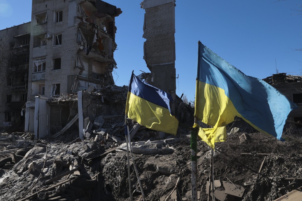 Ukrainian flags wave in front of damaged residential buildings in Orikhiv, near the frontline in the Zaporizhzhia region. Photo: EPA-EFE