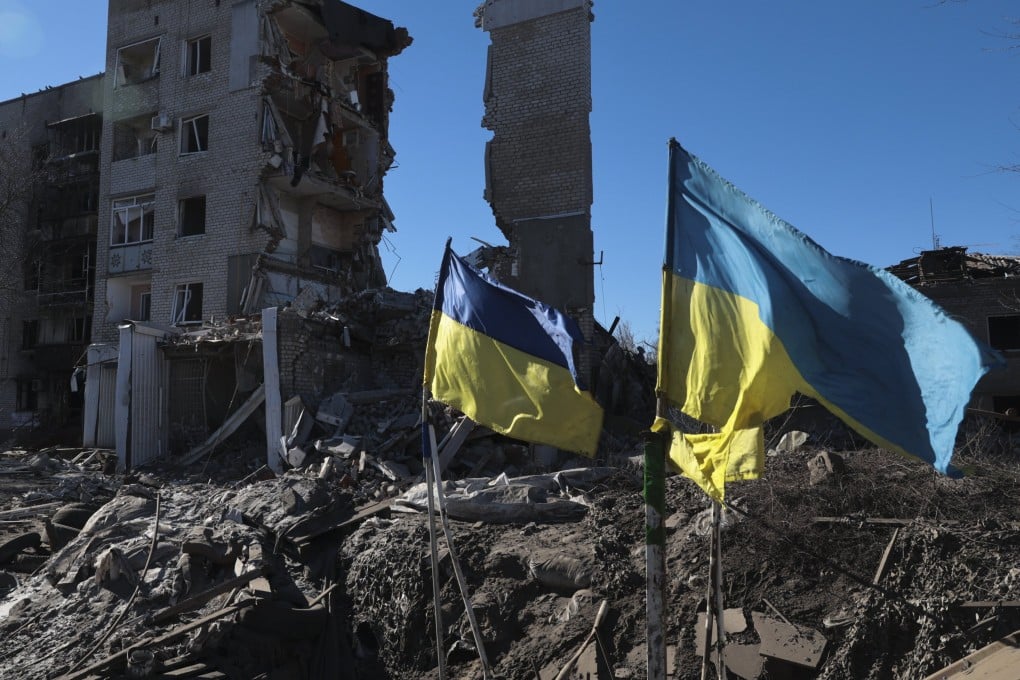 Ukrainian flags wave in front of damaged residential buildings in Orikhiv, near the frontline in the Zaporizhzhia region. Photo: EPA-EFE