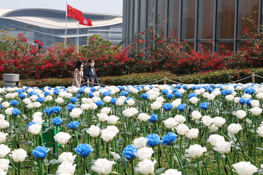 Commuters walk past  a sea of LED plastic  flowers displayed at Tamar Park, Admiralty, which is bordered by the government headquarters, in February 2023. Photo: Yik Yeung-man