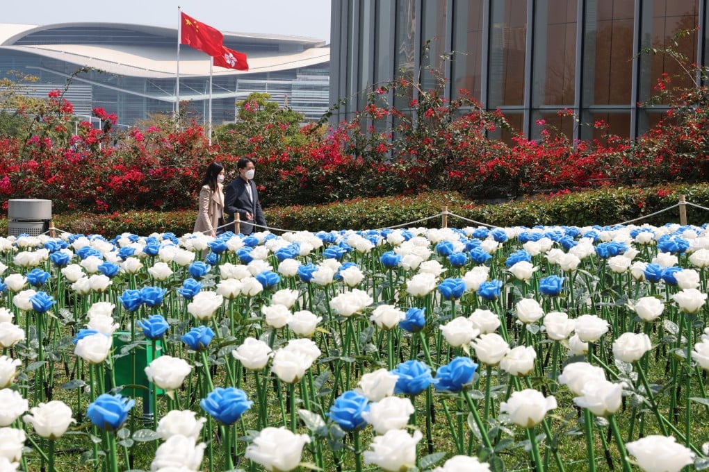 Commuters walk past a sea of LED plastic flowers displayed at Tamar Park, Admiralty, which is bordered by the government headquarters, in February 2023. Photo: Yik Yeung-man
