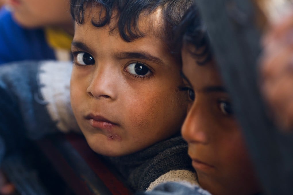 Palestinian children wait to receive food cooked by a charity kitchen amid shortages of food supplies, as the ongoing conflict between Israel and the Palestinian Islamist group Hamas continues. Photo: Reuters