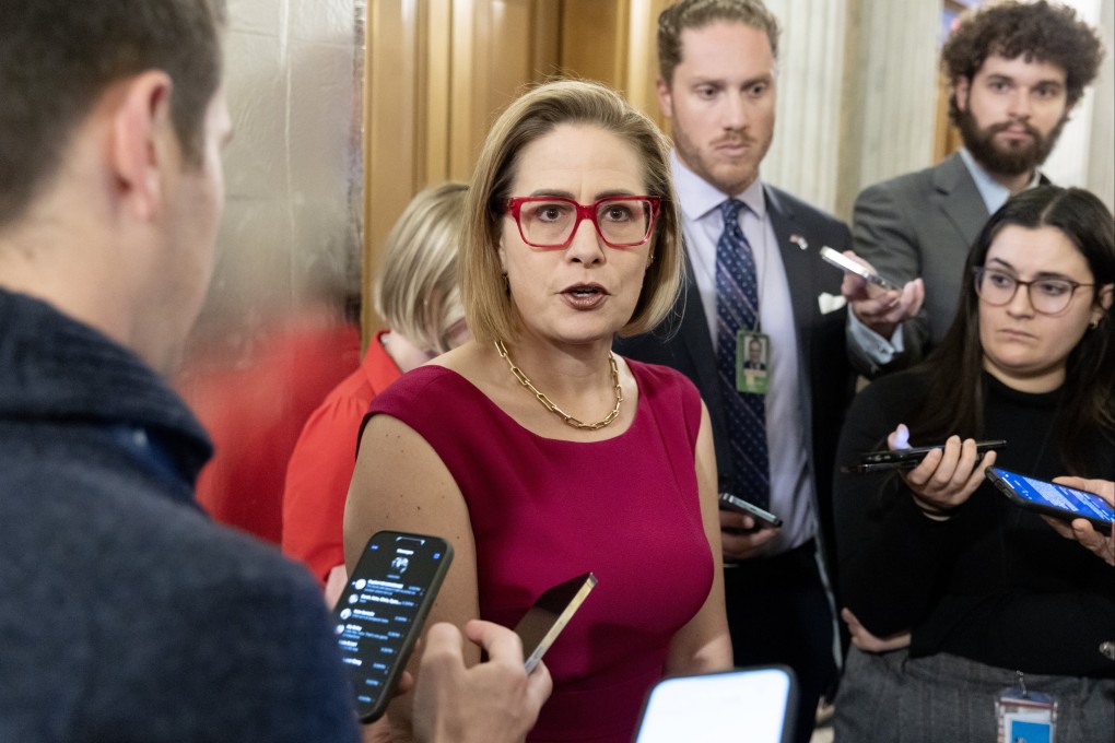 US Senator Kyrsten Sinema (centre) speaks to members of the news media in Washington in February. Photo: EPA-EFE