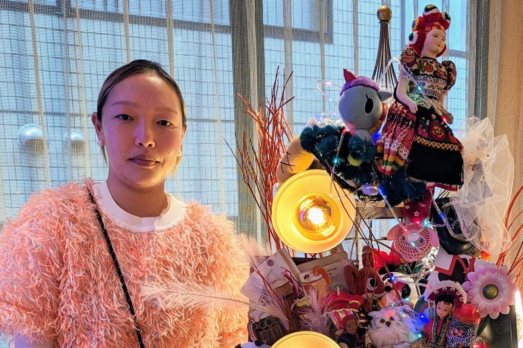 Songhe Kim and her standing chandelier, made from dolls and other discarded items, in the lobby of Lyf Ginza Tokyo, a co-living space in Ginza in the Japanese c capital. Photo: Lisa Cam