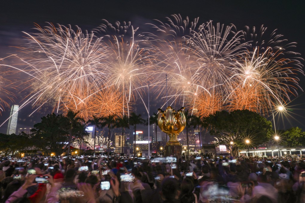 Crowds watch a fireworks display over Victoria Harbour on the second day of the Year of the Dragon, in Hong Kong, on February 11. Photo: Eugene Lee