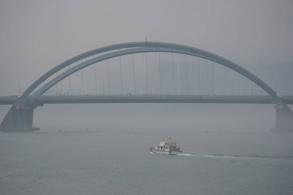 Hong Kong’s urban skyline is barely visible past the Tseung Kwan O Cross Bay Bridge. Photo: Eugene Lee