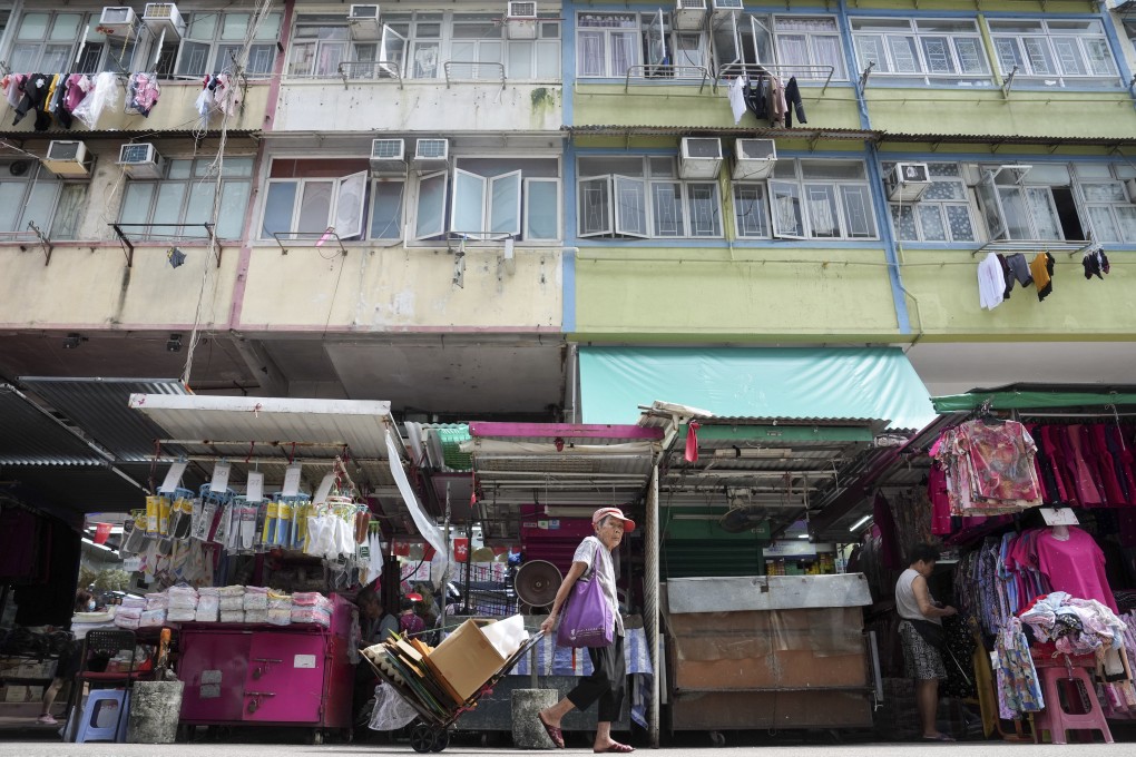 A woman pulls a trolley. Care teams assigned to reach out to needy households will get extra subsidies. Photo: Elson LI