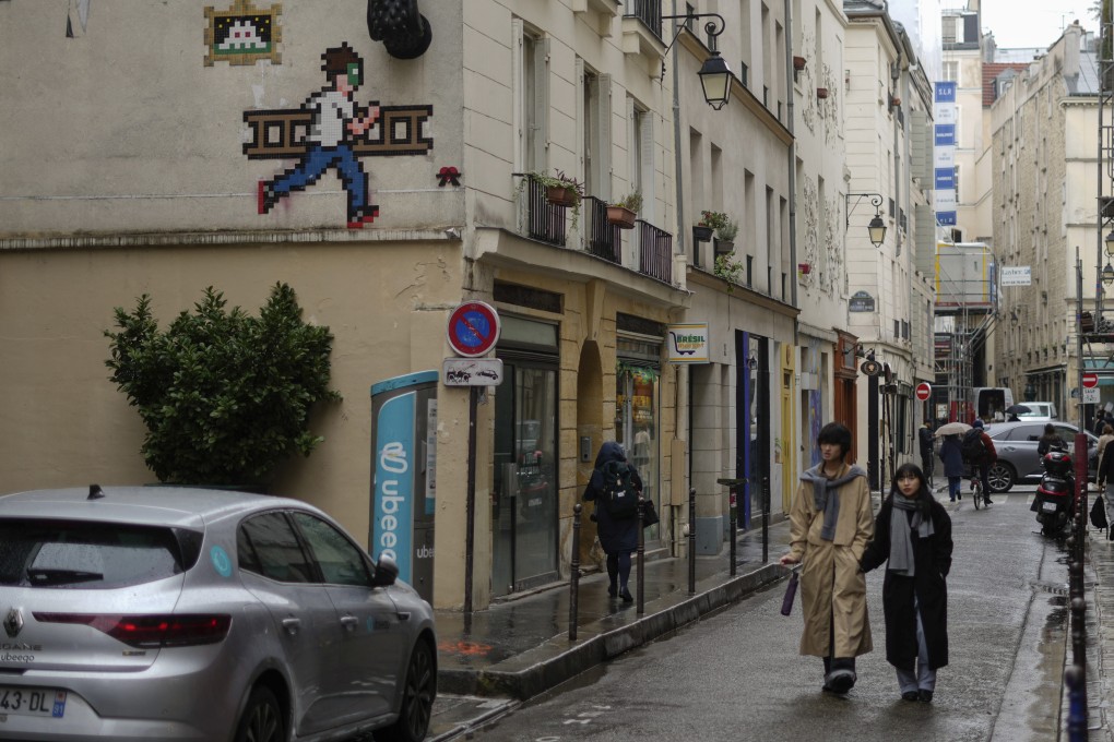 A mosaic by French street artist Invader (top left) on a building in Paris. The mysterious artist’s work is more prominent than ever in the French capital, leading some to wonder what he has in store for the upcoming Olympic Games. Photo: AP