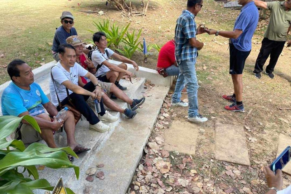 Phuket residents sit on the stairway that has been at the centre of an assault case involving a Swiss expat and a Thai doctor. Photo: Facebook