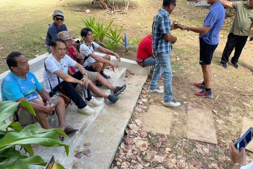 Phuket residents sit on the stairway that has been at the centre of an assault case involving a Swiss expat and a Thai doctor. Photo: Facebook