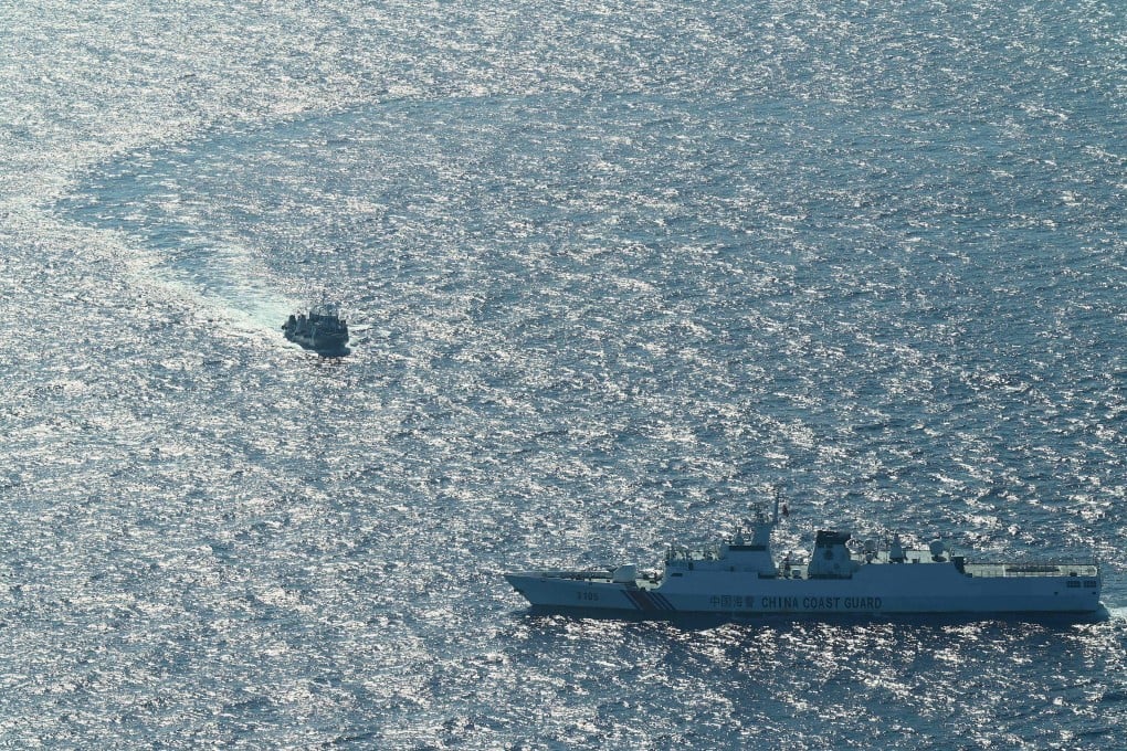 A Philippine Bureau of Fisheries and Aquatic Resources vessel on a mission to resupply fishermen is blocked by a China Coast Guard vessel at Scarborough Shoal on February 15. Photo: AFP