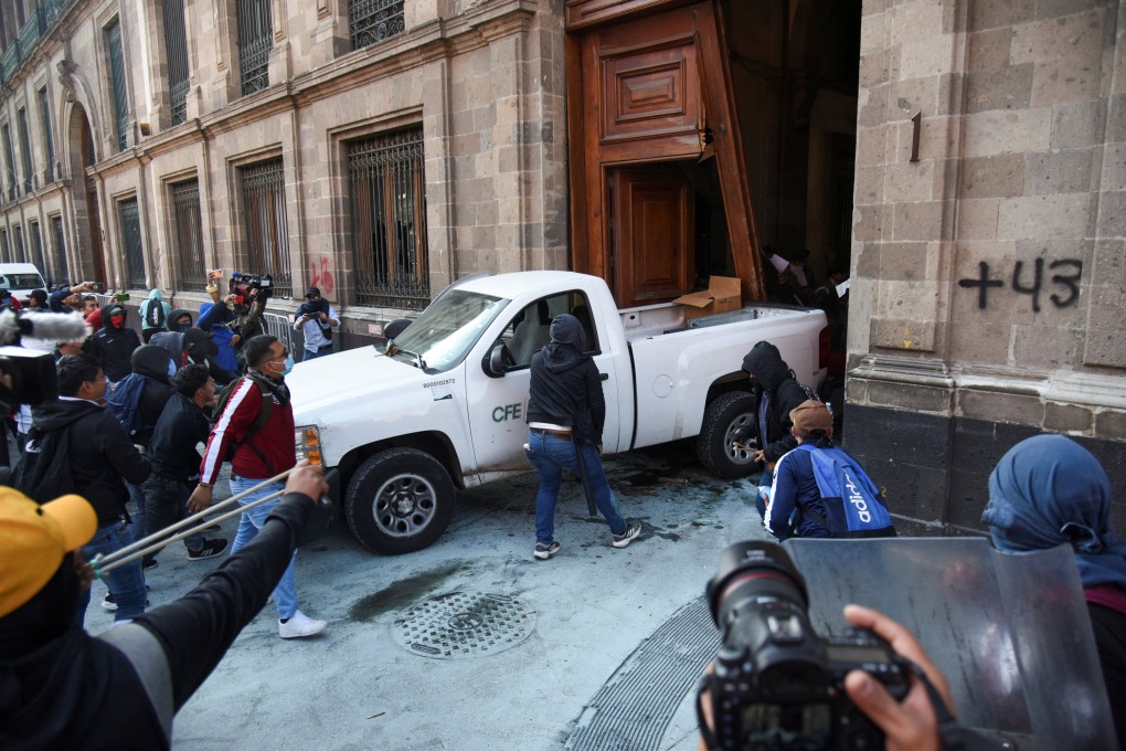 Protesters force their way into the National Palace in Mexico City on Wednesday. Photo: Reuters