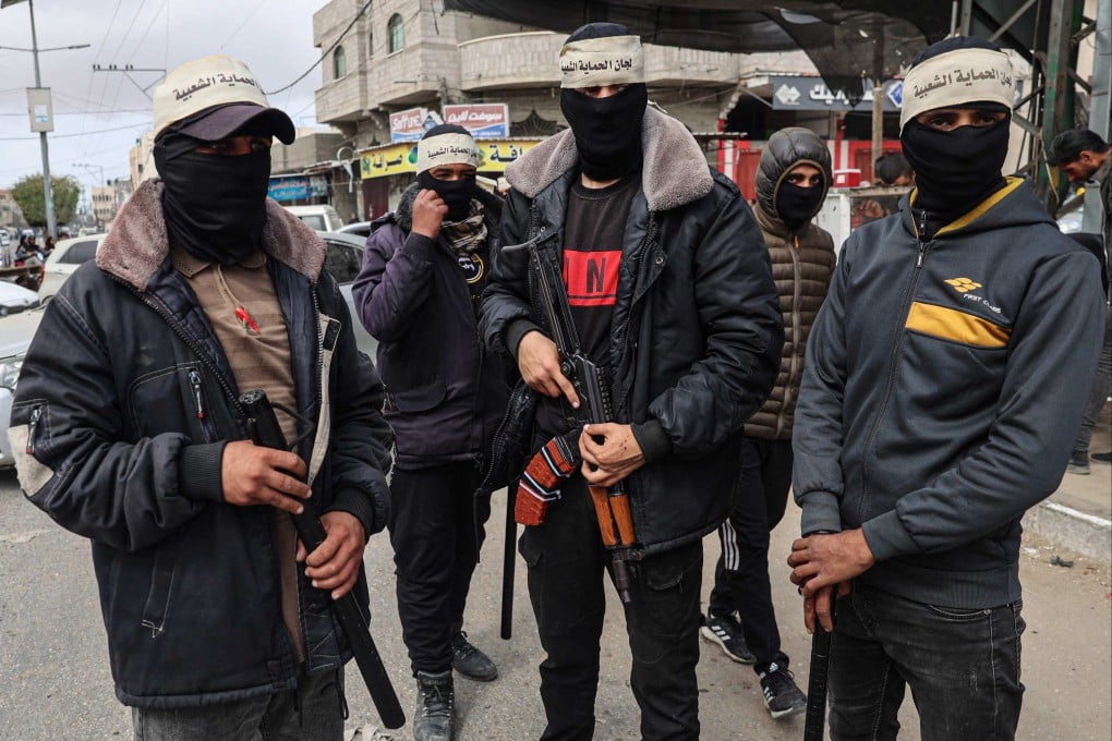 Masked men, some armed with batons and guns, patrol the streets of Gaza’s southern city of Rafah. Photo: AFP