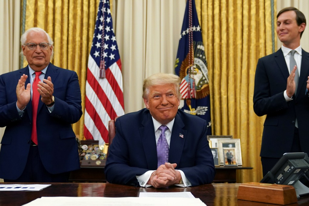Then president Donald Trump is applauded by his ambassador to Israel David Friedman and White House senior adviser Jared Kushner on August 13, 2020. Photo: Reuters