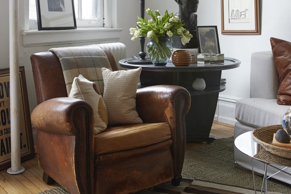 A vintage leather armchair and two-tiered table take pride of place in a living room. Designer Dan Mazzarini says such “slow decorating” includes an appreciation for high-quality and sustainable vintage pieces. The home trend is seen as fighting back against fast furniture brands like Ikea. Photo: AP