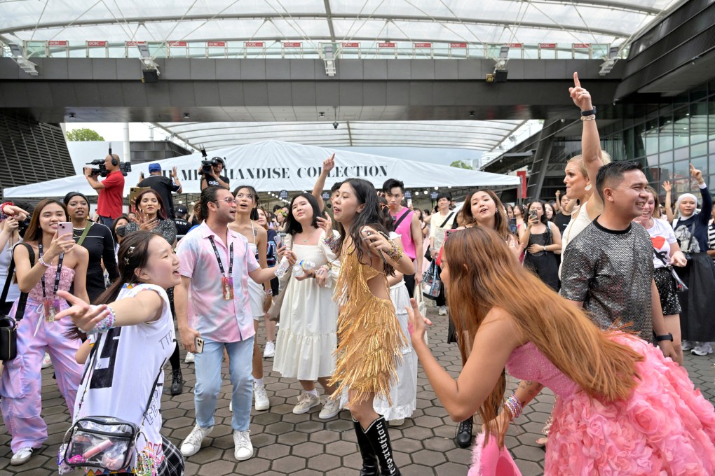 Fans of singer Taylor Swift dance to her music at the National Stadium during a concert in Singapore on March 2. Photo: Reuters