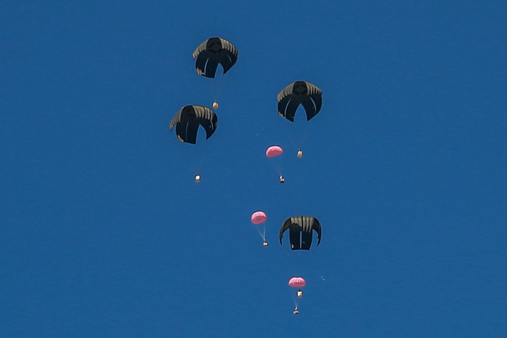 Pink aid parcels, reportedly to mark International Women’s Day, are airdropped over the northern Gaza Strip on Friday. Photo: AFP