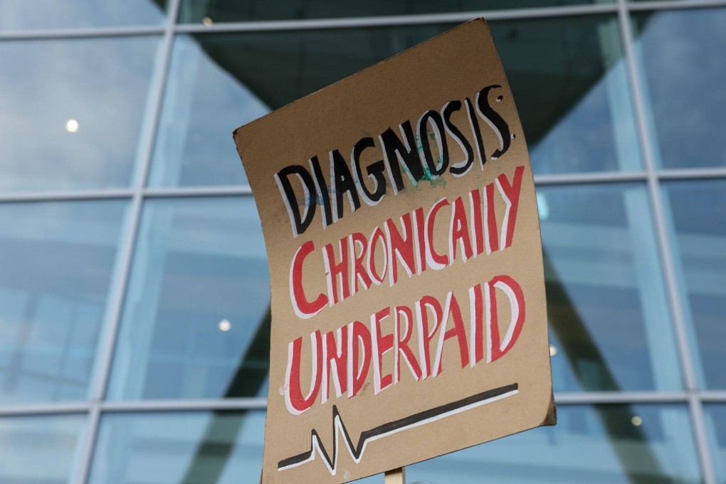 A placard with a slogan that reads “Diagnosis: Chronically Underpaid” on a picket line outside University College Hospital in London, UK, on July 13, 2023. Photo: Bloomberg