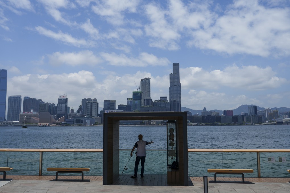 A man fishing under the sunshine at the Wan Chai waterfront on May 23, 2023. Photo: Sam Tsang