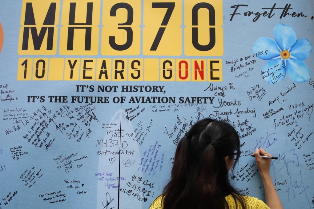A woman writes on a message board during the 10th annual remembrance of the disapperance of Malaysia Airlines Flight 370 at a shopping mall in Subang Jaya, near Kuala Lumpur. Photo: AP