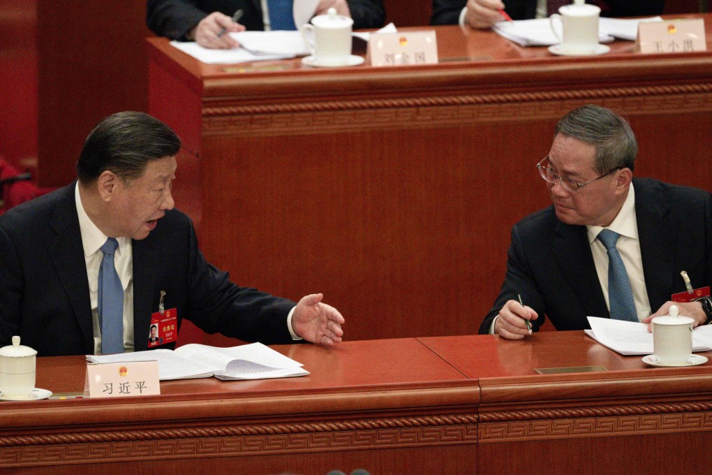 Chinese President Xi Jinping (left) speaks with Premier Li Qiang during the annual meeting of China’s top legislature in Beijing on Friday. Photo: AFP